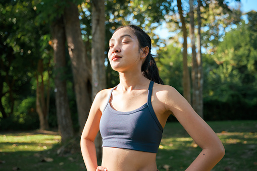 Young woman pauses for a deep breath of fresh air, enjoying her clear sinuses thanks to a daily sinus rinse.